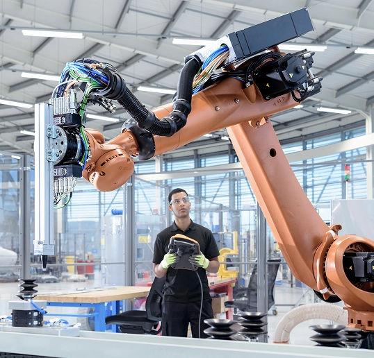 Industrial robot arm operating in a manufacturing environment